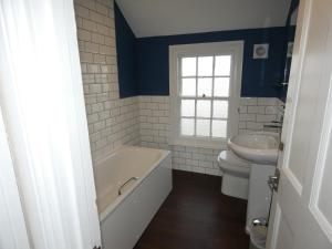 a bathroom with a tub and a toilet and a sink at The Sloop Inn in Kingsbridge