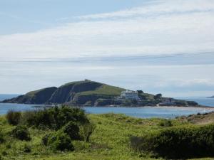 a house on top of a hill in the ocean at The Sloop Inn in Kingsbridge