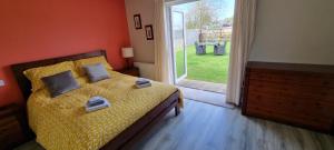 a bedroom with a bed and a sliding glass door at Spacious Curragh 2-bed apartment with own entrance in Brownstown Cross Roads