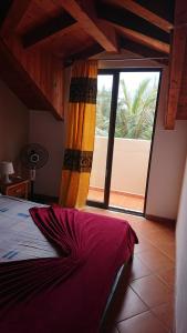 a bedroom with a bed and a large window at Porto Antigo 2 in Santa Maria