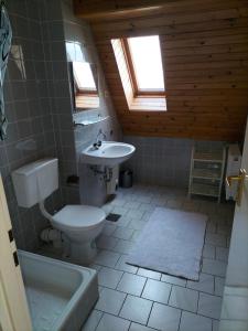 a bathroom with a toilet and a sink at Dom nad morzem u Ewy Chłopy in Chłopy