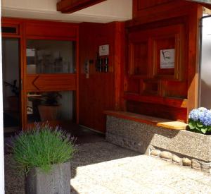 a restaurant with red walls and a window and plants at Carpediem Apartments in Schönwald