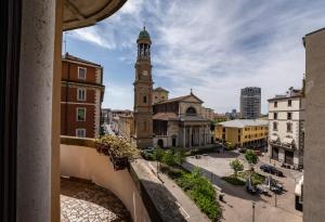 a view from a window of a building with a clock tower at Edo's apartment in Milan