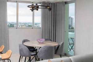 comedor con mesa y sillas en New Modern Lux City Condo With Pool And Gym Ocean View Santo Domingo, en Ciudad Nueva
