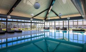 uma grande piscina num edifício com janelas em Rydges Horizons Snowy Mountains em Jindabyne