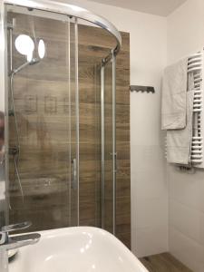 a bathroom with a shower and a sink at UniQue 106 in Gdynia