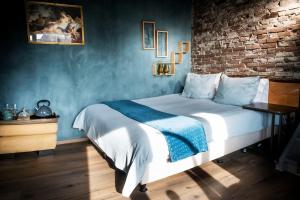 a bedroom with a bed with a brick wall at Mylos Studios in Alkmaar