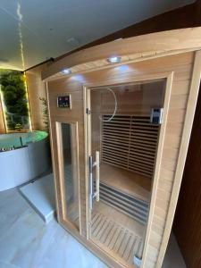 a large bathroom with a shower and a sink at Esprit BALI ....LOVE SPA, Sauna de luxe à Mulhouse in Mulhouse