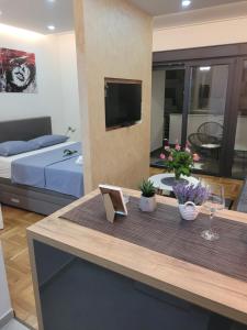 a living room with a table and a bed at TILA 2 in Trebinje