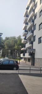 a car parked in a parking lot next to a building at TILA 2 in Trebinje