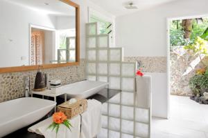 a bathroom with a white sink and a mirror at Sau Bay Resort & Spa in Waiyevo