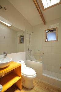 a bathroom with a toilet and a sink and a shower at Cabañas en la naturaleza a pasos de la Playa in La Serena