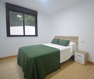 Ένα ή περισσότερα κρεβάτια σε δωμάτιο στο Apartamentos Playa Area Grande
