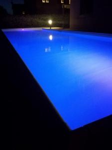 a swimming pool lit up with blue lights at Casa Vacanze Arianna in Rosia