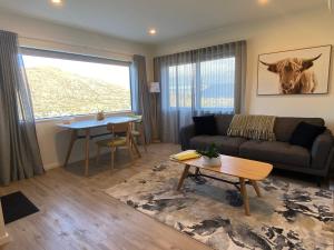 a living room with a couch and a table at Luckie Lane Homestay in Queenstown