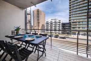 a table and chairs on a balcony with a view of a city at Apartment 2 bedrooms with magnificent seaview and free parking in Ostend