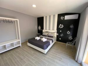 a bedroom with a bed and a flat screen tv at Cantinho do Sol (Estúdio Prata) in Lourinhã +12 photos