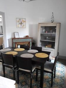 a dining room with a black table and chairs at Maison de ville proche beauval avec parking in Selles-sur-Cher