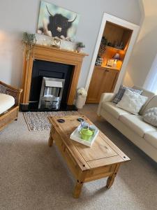 a living room with a couch and a coffee table at The Ramblers Rest - whole apartment - pet friendly - close to amenities and walks in Edzell