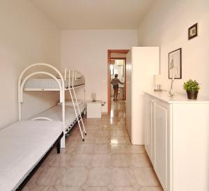 a bedroom with a bunk bed and a person in a doorway at GAYA MARINA in Lido Marini