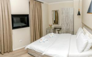 Postel nebo postele na pokoji v ubytování Hotel Pazari & Apartments