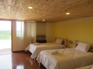 Postel nebo postele na pokoji v ubytování Ecohotel, Finca Colinas y Senderos