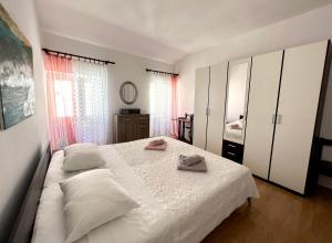 a bedroom with a bed with two towels on it at Apartment Moris in Vodnjan