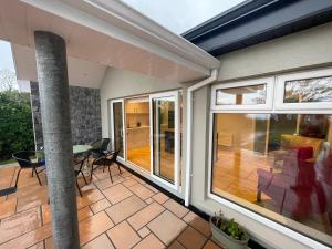 a house with a patio with a table and chairs at Sea View Lodge in Sligo