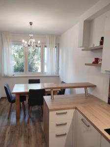 a kitchen with a wooden table and a dining room at Apartment MM Split in Split
