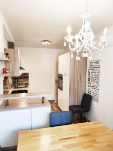 a kitchen with a dining table and a chandelier at Apartment MM Split in Split