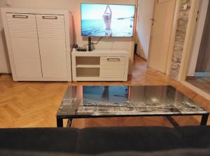 a living room with a tv and a coffee table at Apartment MM Split in Split