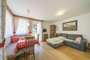 a living room with a couch and a table at Apartment Romana in Selva di Val Gardena