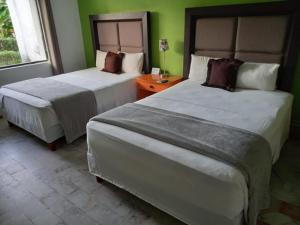 Postel nebo postele na pokoji v ubytování Nirvana Hotel - Cancun Hotel Zone