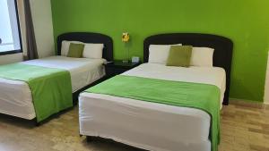 Postel nebo postele na pokoji v ubytování Nirvana Hotel - Cancun Hotel Zone
