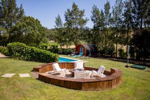 a group of chairs and a table and a pool at Alfaro'95 in Azambuja