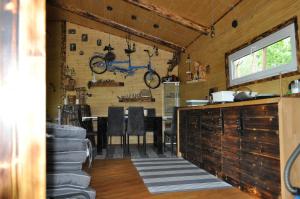 a room with a table and a bike on the wall at Willa na Drzewie in Rudka Gołębska