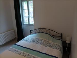 a bedroom with a bed and a window at O'Couvent - Appartement 524 - 5 chambres - 125 m2 - Deuxième étage in Salins-les-Bains