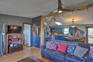 a living room with a couch and a kitchen at Cozy Black Hills Home 13 Acres with Deck and Views! in Hot Springs
