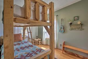 a bedroom with a bunk bed and a room with a desk at Cozy Black Hills Home 13 Acres with Deck and Views! in Hot Springs