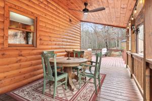 a wooden deck with a table and chairs on it at Relaxing Cabin near Bear Claw Vineyard, Hot Tub, Game Room, Pet Friendly, sleeps10 in Blue Ridge