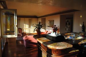a living room with a bed and a kitchen with a table at Hotel Locanda San Giacomo in Agliano Terme