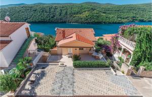 an aerial view of a house with a lake at Amazing Apartment In Labin With Kitchen in (( Hrvatini ))