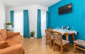 a living room with a table and a couch at Cozy Apartment In Crikvenica With Wifi in Crikvenica