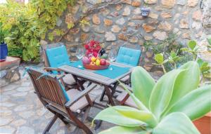 a table and chairs with a bowl of fruit on it at 3 Bedroom Beautiful Home In Almuñecar in Almuñécar +20 photos