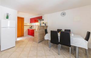 a kitchen and dining room with a table and chairs at Lovely Apartment In Pavicini With Wifi in Pavicini