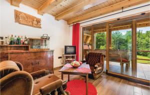 a living room with a table and chairs at Cozy Home In Delnice With Kitchen in Delnice