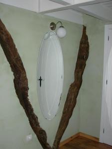 a white surfboard on a wall in a room at Casa Rural La Ardina in Sotres