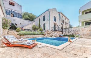 a house with a swimming pool in front of a building at Beautiful Home In Tkon With Outdoor Swimming Pool in Tkon