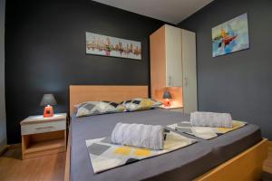 a bedroom with a large bed with at Apartments Hudovernik in Baška Voda +84 photos