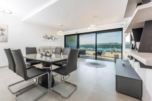 a kitchen and dining room with a table and chairs at Apartment MaLu in Banjole